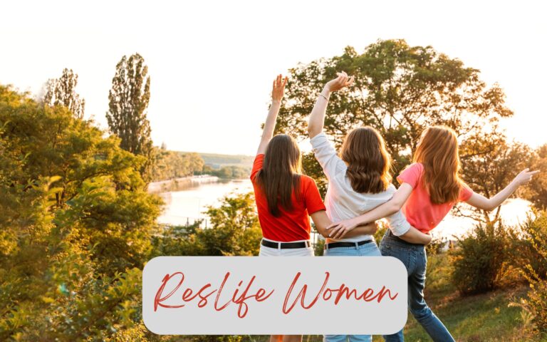 ResLife Women's Events - image of 3 woman hugging and looking out over a lake at sunset